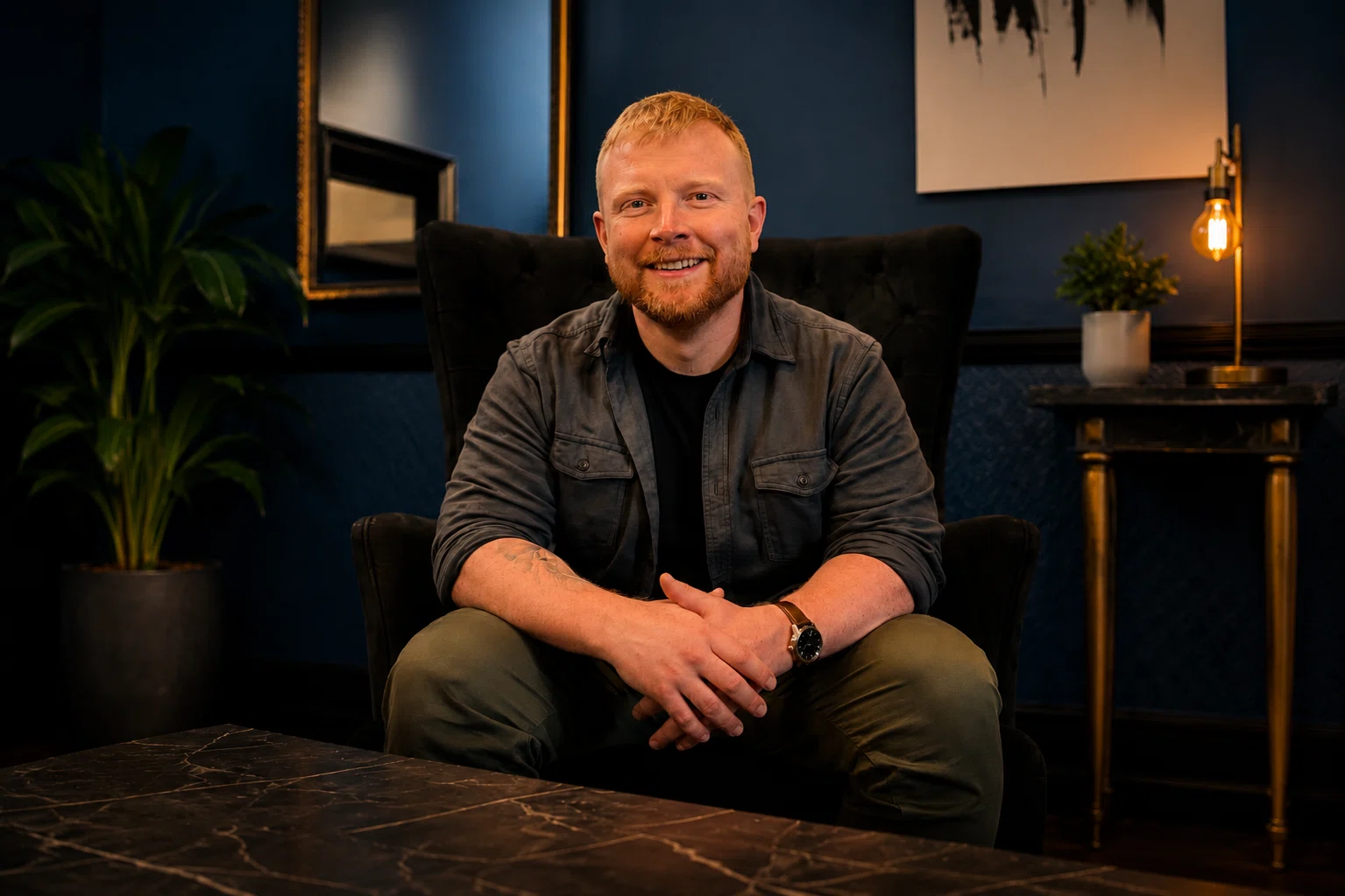 Alex Watson sitting in a warm workspace